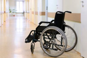 Wheel chair in the hospital corridor. Wheel chair stands in the corridor of the hospital door.